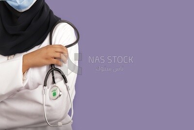 A woman doctor wearing a black hijab