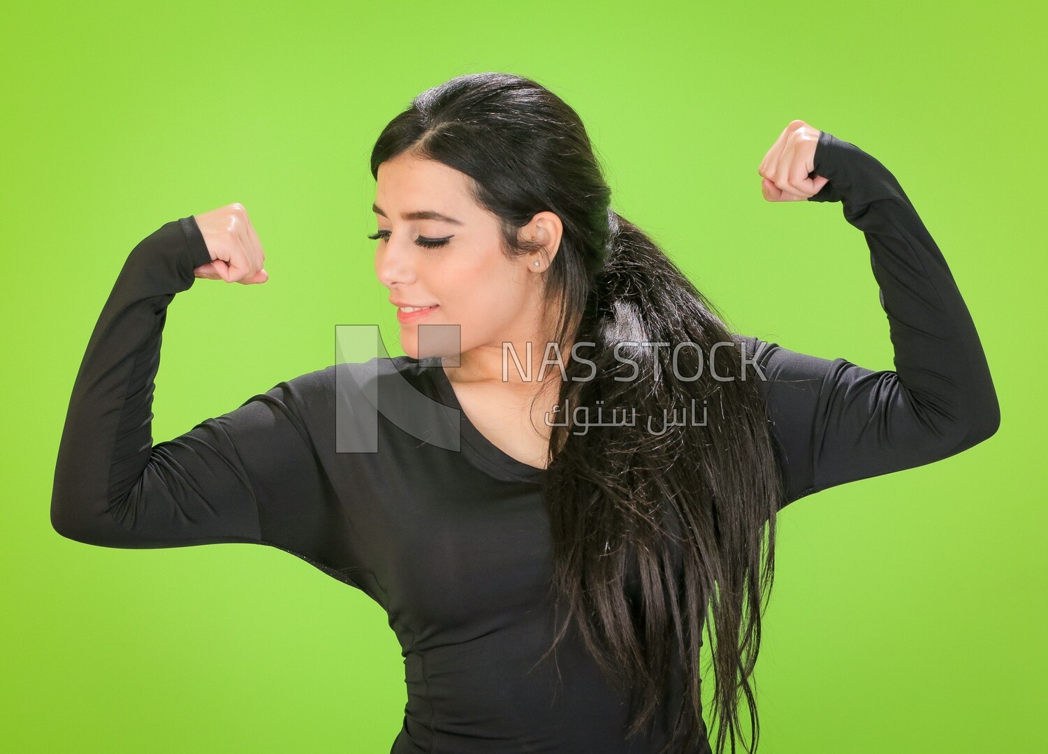 A woman looking at her muscles