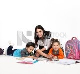 A mother sitting with her kids studying