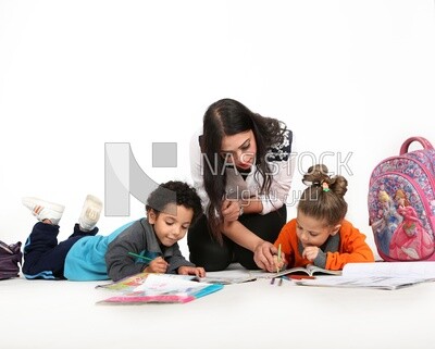 A mother sitting with her kids studying