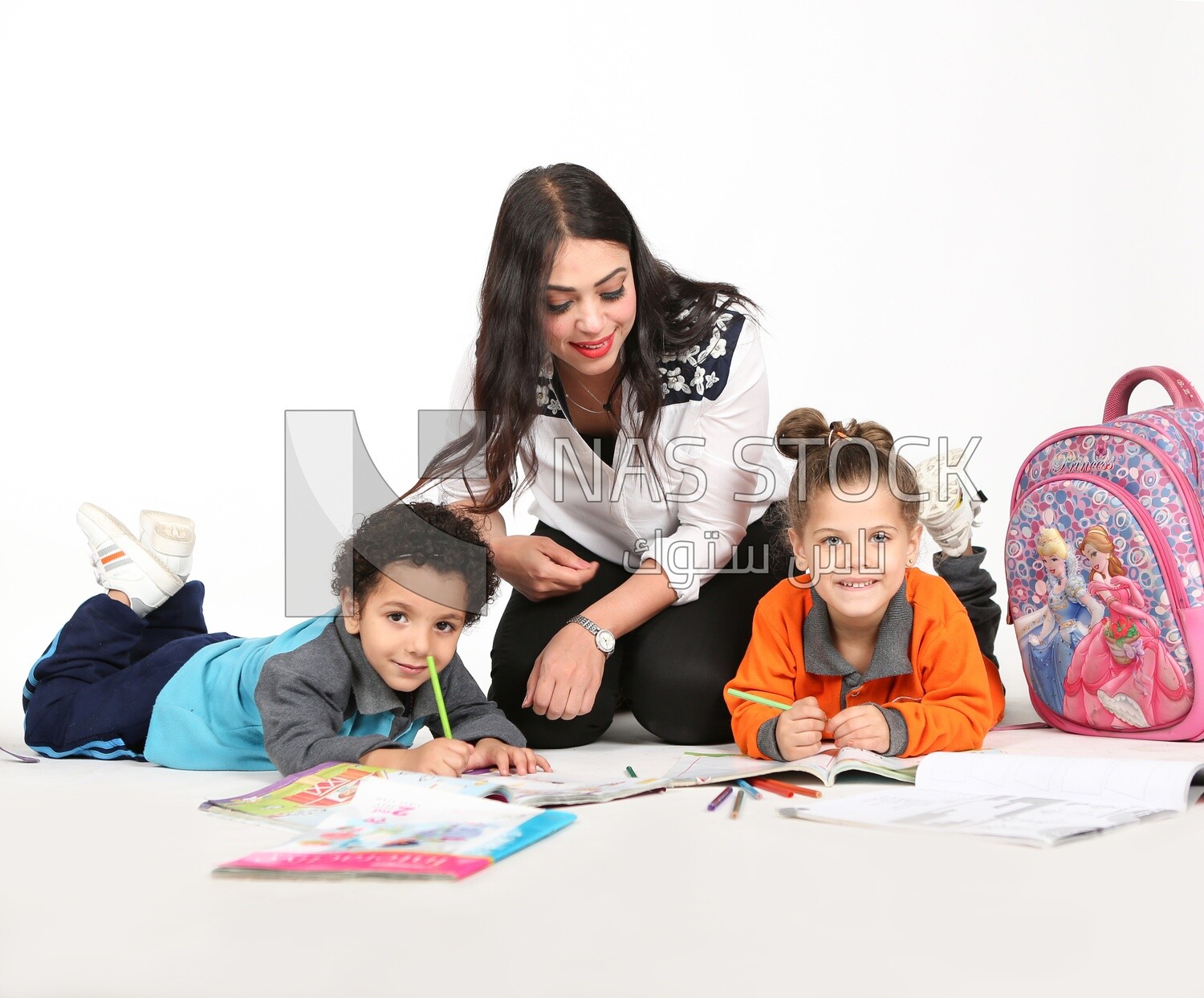 A mother sitting with her kids studying