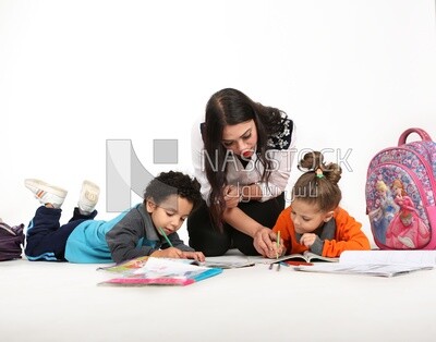 A mother sitting with her kids studying