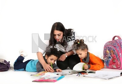 A mother sitting with her kids studying
