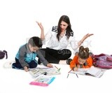 A mother sitting with her kids studying