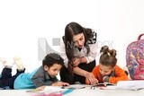 A mother sitting with her kids studying