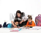 A mother sitting with her kids studying