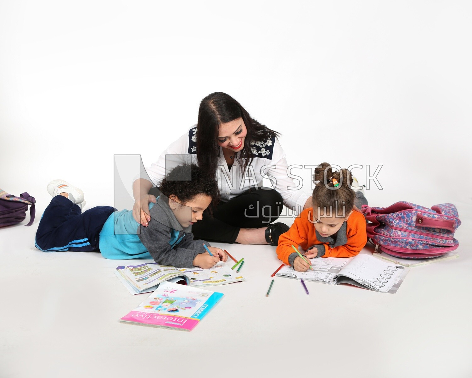 A mother sitting with her kids studying