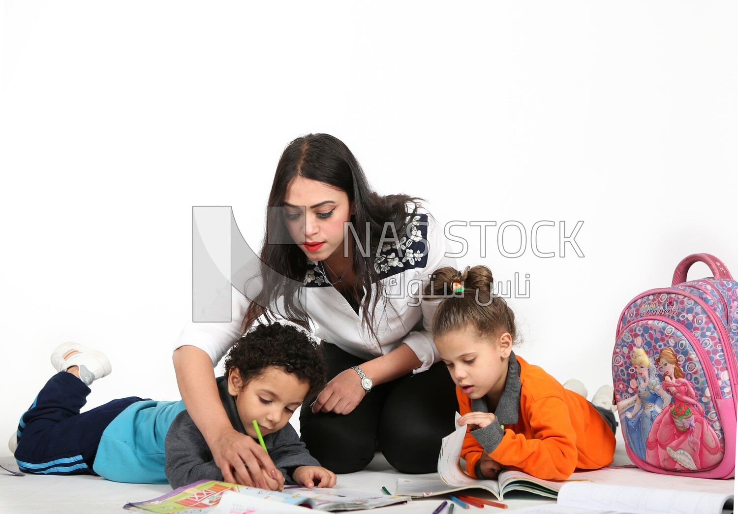 A mother sitting with her kids studying