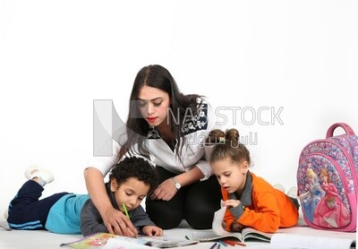 A mother sitting with her kids studying