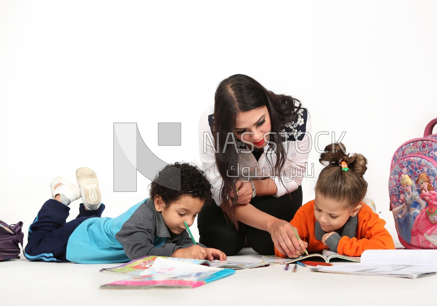 A mother sitting with her kids studying