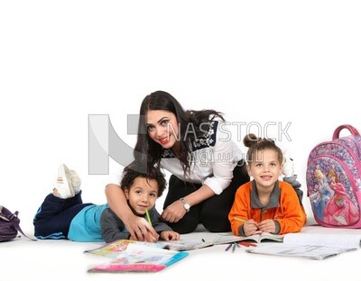A mother sitting with her kids studying