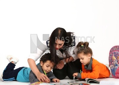 A mother sitting with her kids studying
