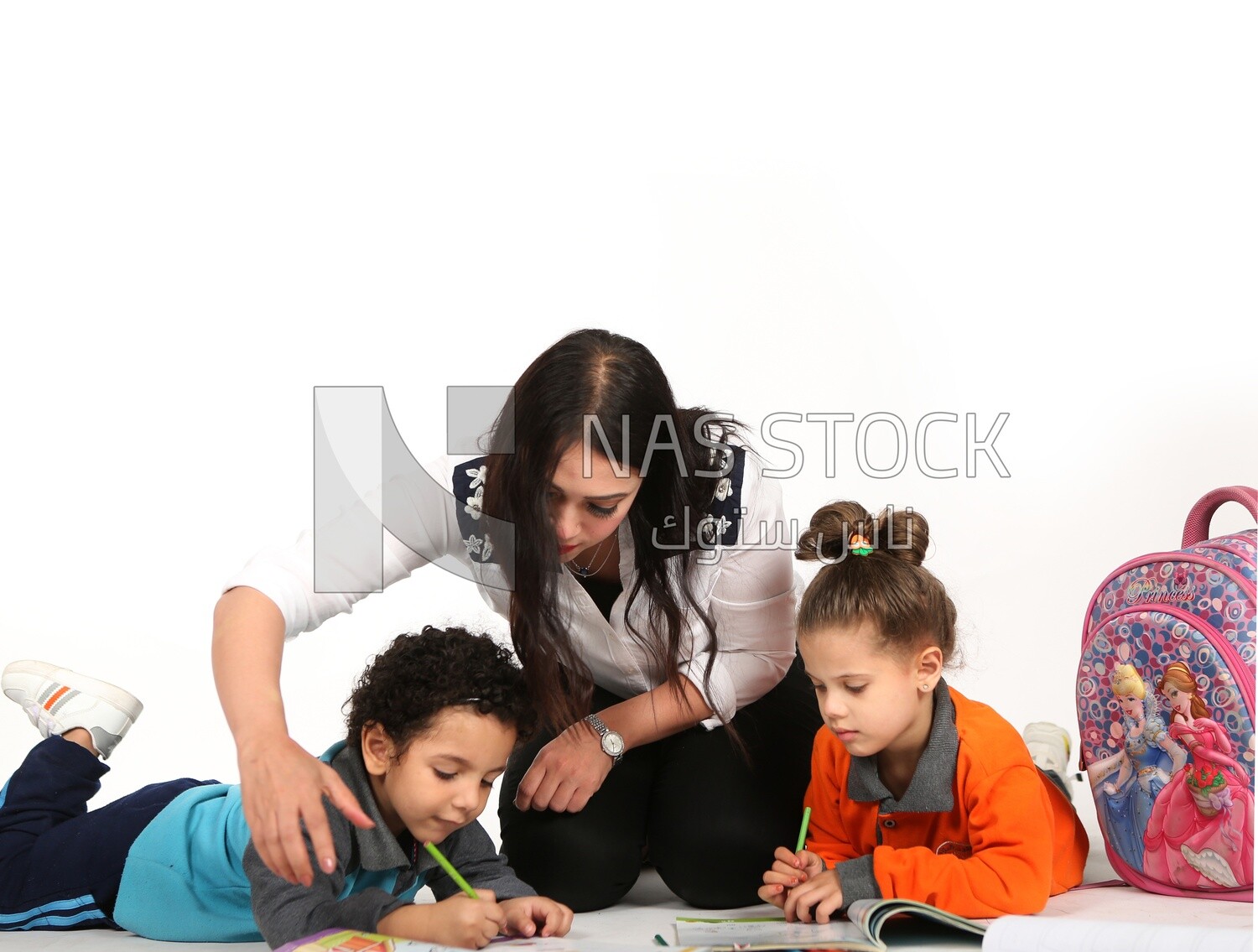 A mother sitting with her kids studying