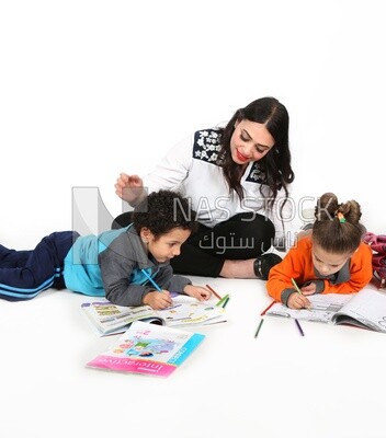 A mother sitting with her kids studying