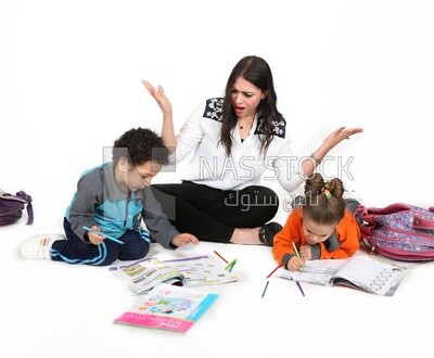A mother sitting with her kids studying