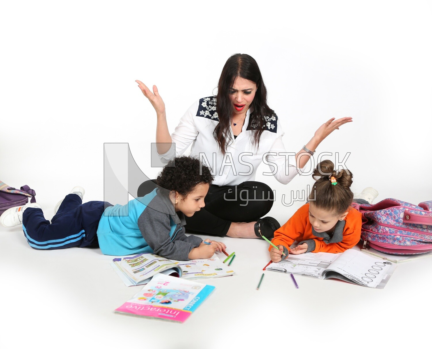 A mother sitting with her kids studying
