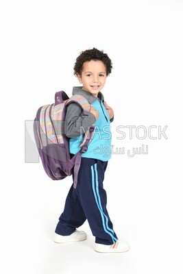 A boy wearing his bag on a white background