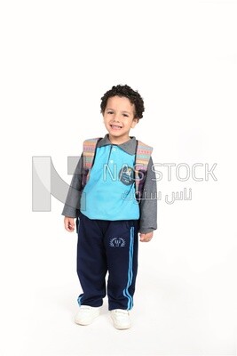 A boy wearing his bag on a white background