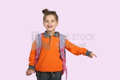 A schoolgirl wearing her bag and pointing