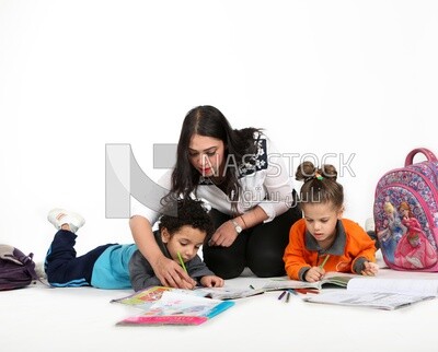 A mother sitting with her kids studying