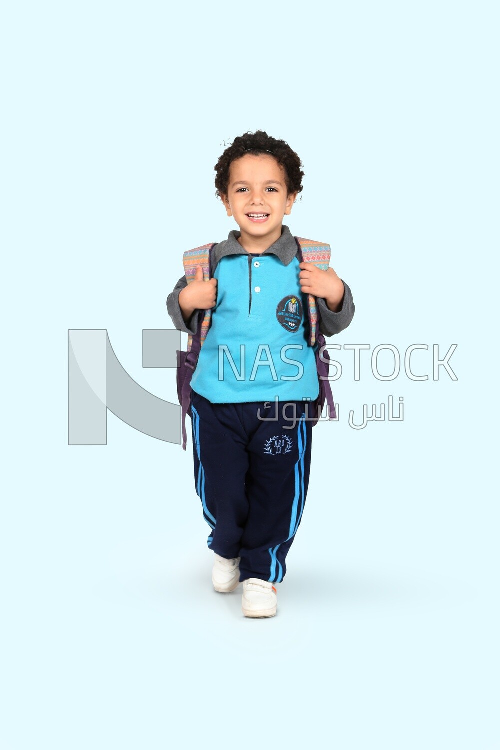Boy wearing his bag on a blue background