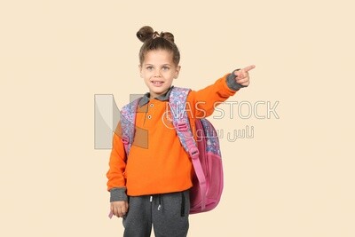 A schoolgirl wearing her bag and pointing