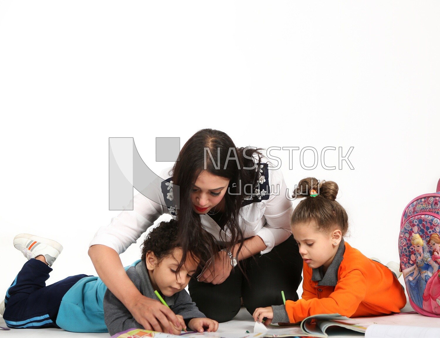 A mother sitting with her kids studying