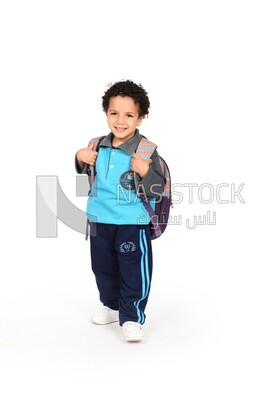 A boy wearing his bag on a white background