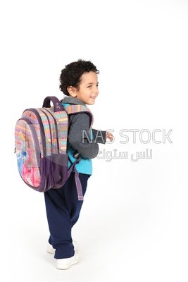 A boy wearing his bag on a white background