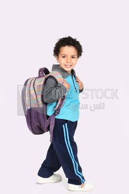 A boy wearing his bag on a white background
