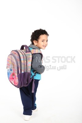 A boy wearing his bag on a white background