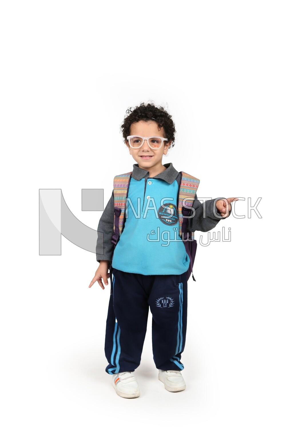 A boy wearing his bag on a white background