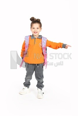 A schoolgirl wearing her bag and pointing