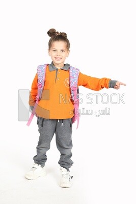 A schoolgirl wearing her bag and pointing