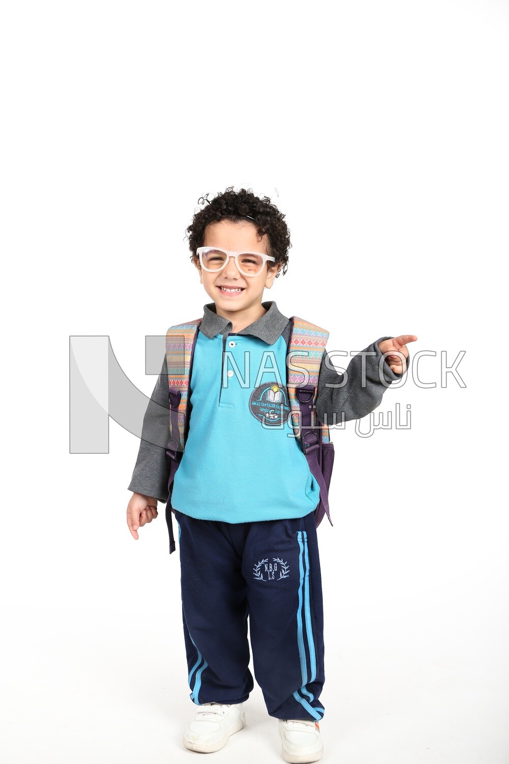 A boy wearing his bag on a white background