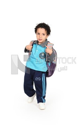 A boy wearing his bag on a white background