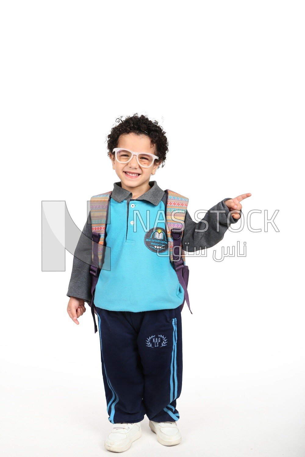 A boy wearing his bag on a white background