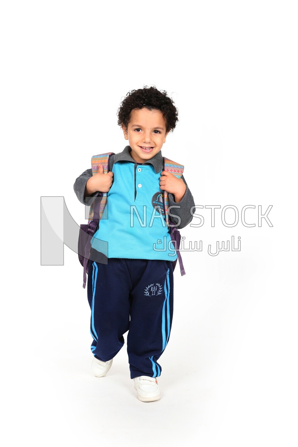 A boy wearing his bag on a white background