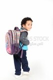 A boy wearing his bag on a white background