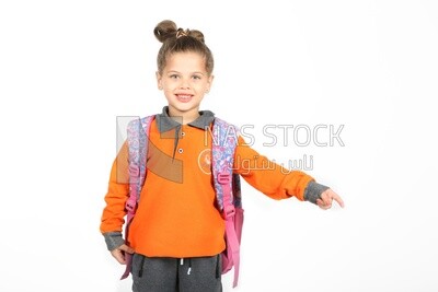 A schoolgirl wearing her bag and pointing