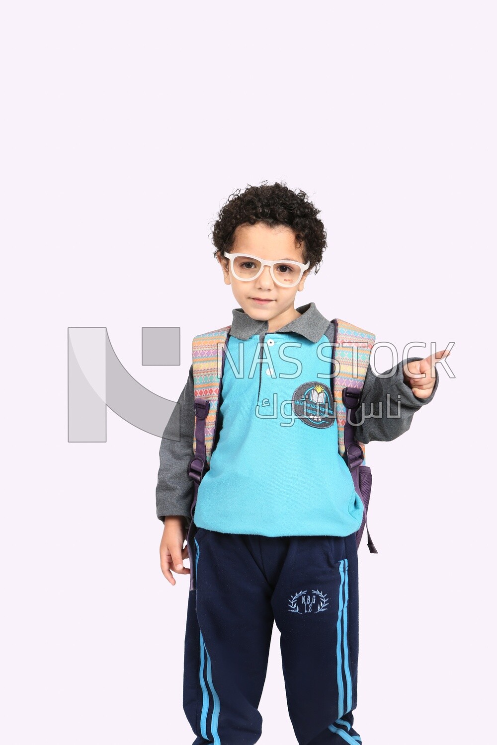 A boy wearing his bag on a white background