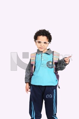 A boy wearing his bag on a white background