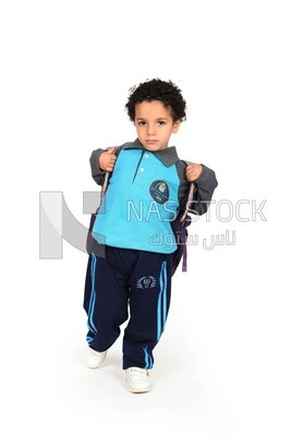 A boy wearing his bag on a white background