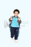 A boy wearing his bag on a blue background