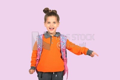A schoolgirl wearing her bag and pointing