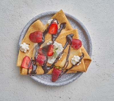 Strawberry crepe covered with chocolate and cream