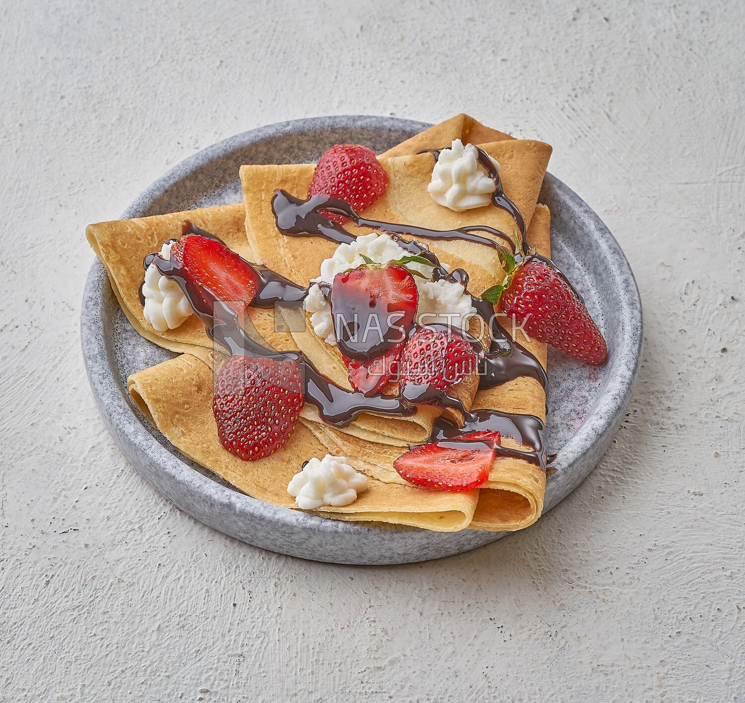 Strawberry crepe with chocolate on a solid background