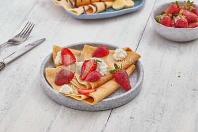 Dining table with a strawberry crepe