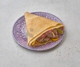 Sausage crepe with vegetables on a solid background