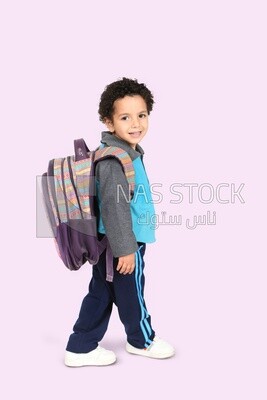 A boy wearing his bag